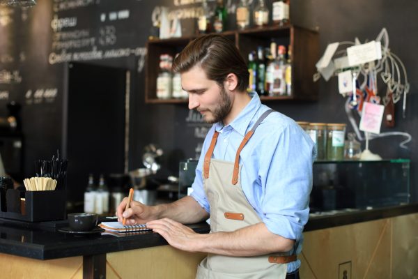 Small business owner working at his cafe
